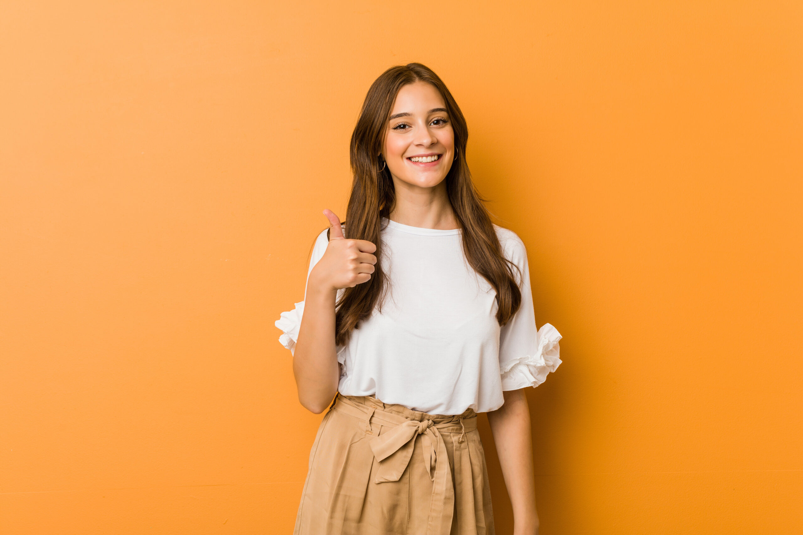 smiling and raising thumb up